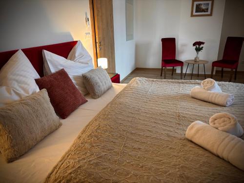 a large bed with two towels on top of it at Resort Nová Včelnice in Nová Včelnice