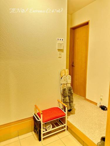 a room with a chair with a red seat at Ten10 in Nagoya