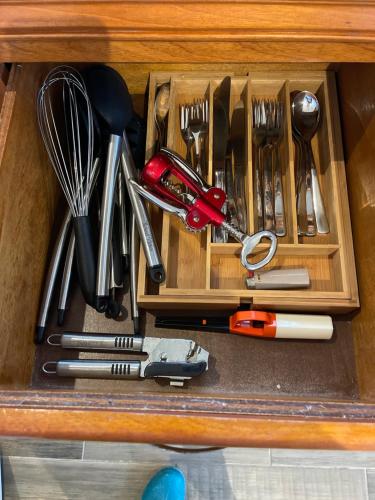 a drawer with utensils in a wooden box at Hidden Treasure Vacation Home Bay Blue Suite 2 in Belize City