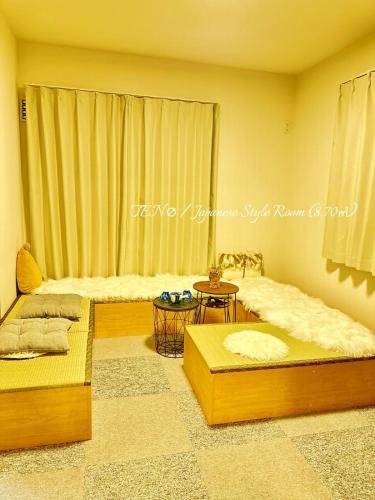 a room with two beds and a window at Ten10 in Nagoya