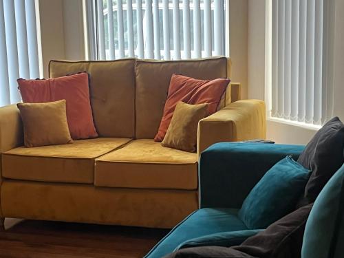 a couch with pillows on it in a living room at Gr8 Hostel at The Mount in Belfast