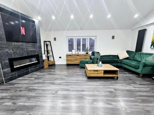 a living room with a couch and a fireplace at The Penthouse Tamworth Spacious 3 Bedroom Apartment in the town centre in Tamworth