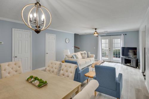 a living room with a table and chairs and a couch at 3 Mi to St Simons Beach Gem with Pool Access and Deck in Saint Simon Mills