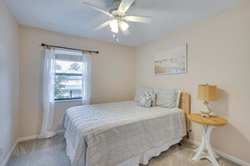 a bedroom with a bed and a ceiling fan at 3 Mi to St Simons Beach Gem with Pool Access and Deck in Saint Simon Mills