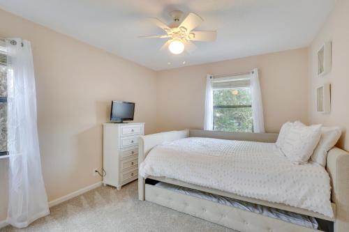 a bedroom with a bed and a ceiling fan at 3 Mi to St Simons Beach Gem with Pool Access and Deck in Saint Simon Mills