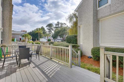 a balcony with two chairs and a table on it at 3 Mi to St Simons Beach Gem with Pool Access and Deck in Saint Simon Mills