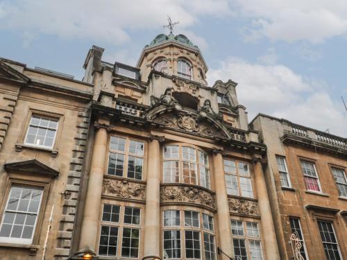 an old building with a clock tower on top of it at 9 Old City Chambers in Bristol