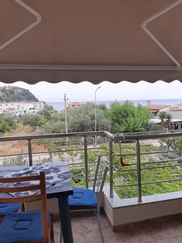 a table and chairs on a balcony with a view at Rexhos Studios in Himare