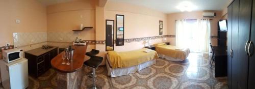 a bathroom with two beds and a sink in a room at Departamentos Anthony in Santa Teresita