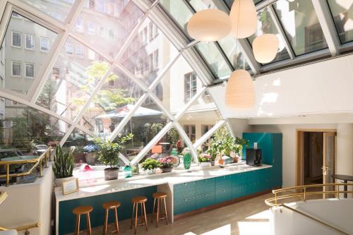 a large window in a building with stools at ProfilHotels Central in Stockholm