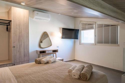 a bedroom with a bed with towels on it at Lemonia Plaka in Plaka