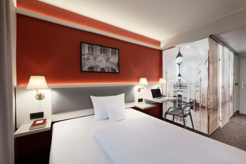 a hotel room with a bed and a desk with a laptop at Best Western Hotel Leipzig City Centre in Leipzig