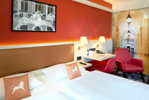 a hotel room with a bed and a desk at Best Western Hotel Leipzig City Centre in Leipzig