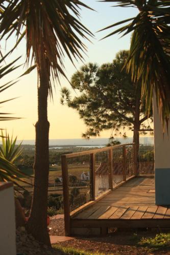 a wooden walkway with a view of the ocean at Monte Sardinha in Santiago do Cacém