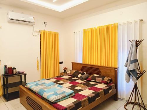 a bedroom with a bed and yellow curtains at Pepper Jazz Varkala in Varkala