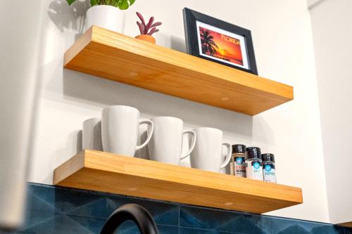 a shelf with cups and bottles on a wall at Boutique Beach Retreat in St Pete Beach