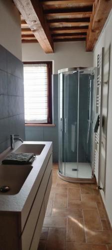 a bathroom with a glass shower and a sink at JesiGreen House in Iesi