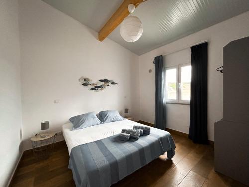 a bedroom with a bed and a window at Monte Sardinha in Santiago do Cacém