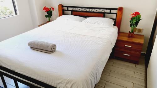 a bed with a white blanket and a pillow on it at Diamond in Kileleshwa Othaya Rd in Nairobi