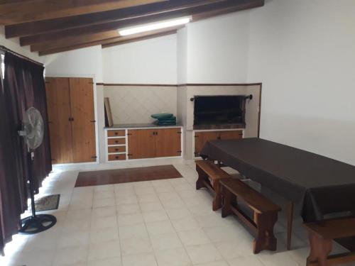 a room with a black table and benches in it at Oscar in Miramar