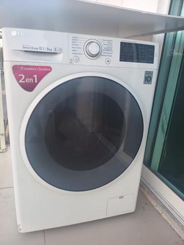 a white microwave oven sitting next to a window at Departamento Inteligente en Colonia Cerrada Vigilancia 7X24 in Monterrey
