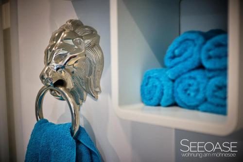 a towel holder in a bathroom with blue towels at Seeoase - Wohnung Am Möhnesee in Möhnesee