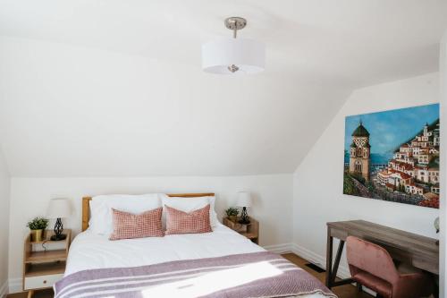 a bedroom with a bed and a painting on the wall at Park and Mill - Hot Tub and Bocce Court in Bloomfield