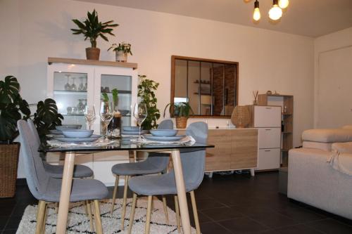 a dining table and chairs in a living room at Chez jades in Saint-Julien-en-Genevois