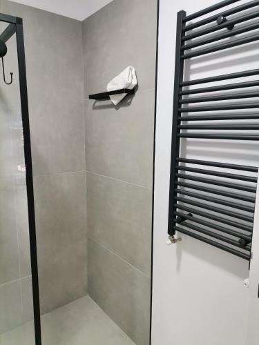 a shower with a glass door in a bathroom at Tutu Studio Sinaia cu vedere panoramica Early Checkin in Sinaia