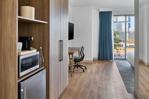 a room with a kitchen with a table and a desk at Element Atlanta Perimeter Center in Atlanta
