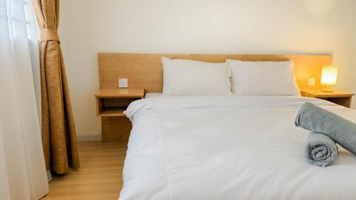 a bedroom with a large white bed with white pillows at Relaxing 3BR Family Home near Zoo with Netflix WiFi in Tupai