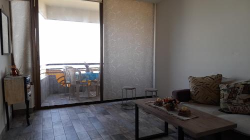 a living room with a couch and a table at Remarkable 2-Bed Chalet in Kaslik in Jounieh