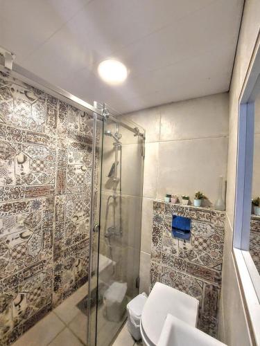 a bathroom with a shower and a toilet at Renovated apartment Generator is included beach in Jounieh