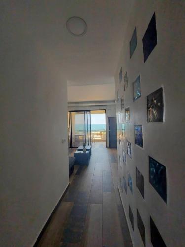 a hallway with a wall with pictures on it at Renovated apartment Generator is included beach in Jounieh