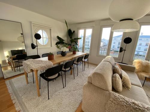 a living room with a couch and a table at New Apartment Disneyland Paris Panoramic view 8 PAX, 2 parking in Serris