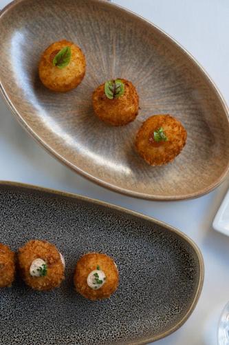 a plate of food on a table next to a plate of food at CoolRooms Palacio de Atocha in Madrid