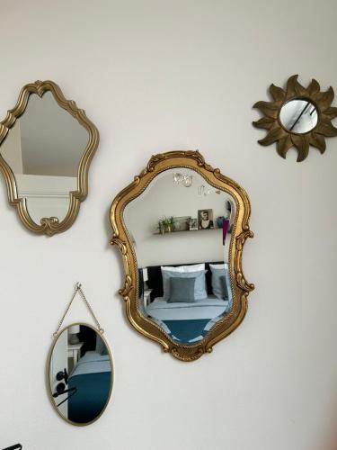 a mirror hanging on a wall with a room at B&B Zeeuws genoegen in Vlissingen