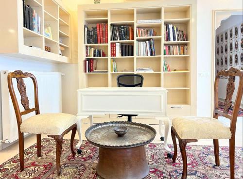 a room with two chairs and a table and a desk at Centrally Located Very Large Villa W Pool Jakuz and Car Park in Fethiye