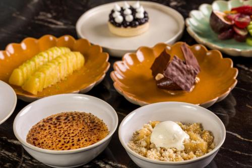 a table with plates of different types of desserts at Maison Albar - Amoure in Braga