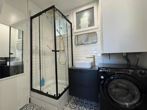 a bathroom with a shower and a washing machine at Duplex - 5 min Insead - Close to Forest and Castle in Fontainebleau