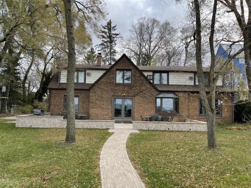 a brick house with a walkway in front of it at The Pelton House in New Buffalo