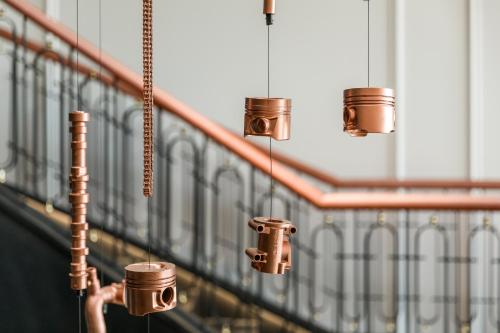 a row of coffee cups hanging from a wall at Maison Albar - Amoure in Braga