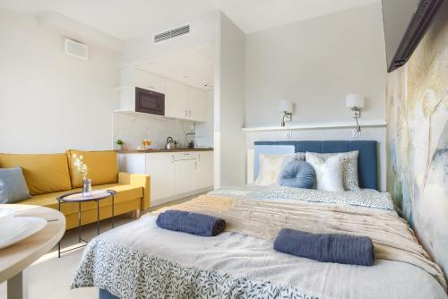 a bedroom with a large bed with two pillows on it at SuperApart Modern Stay Ursynów Pileckiego - Parking w cenie in Warsaw