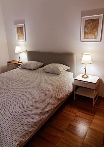 a bedroom with a bed with two lamps on it at Lagos Factory Yellow by Marina with AC in Lagos