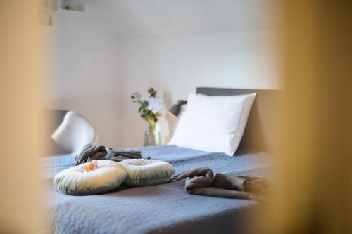 two people laying on a bed with two pillows at Villa Cecha B&b &Wellness in Ostend