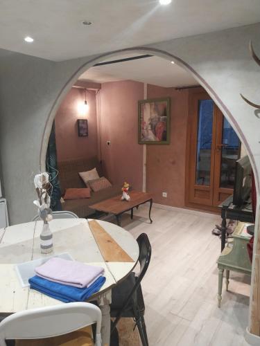 a living room with a table and a couch at La Cérisole in Saint-Étienne-de-Tinée