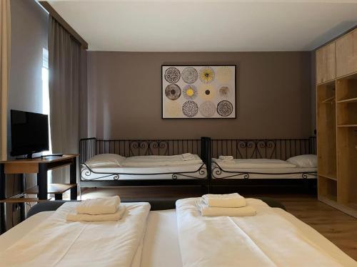 two beds in a room with two beds sidx sidx sidx at The Art and Sporthotel in Innsbruck