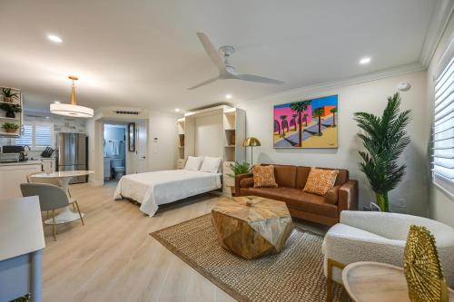 a living room with a bed and a living room with a couch at Naples Studio 1 Block to Beach and Restaurants! in Naples