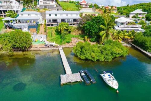 a boat is docked at a dock in the water at Villa confortable avec piscine à Hyacinthe – 95 m² in Hyacinthe