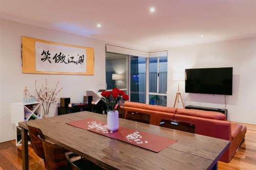 a living room with a table and a couch at Waterfront Home Rockingham in Rockingham
